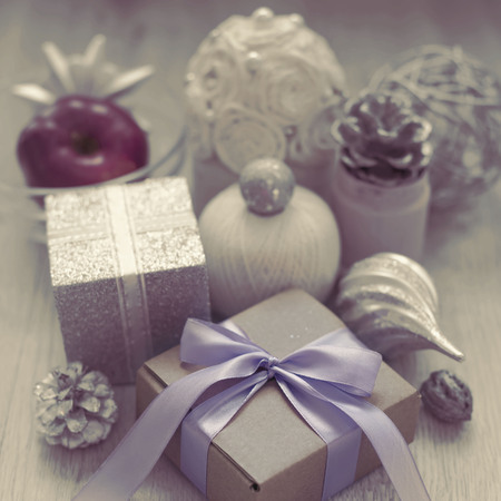 Surrealism Christmas composition with gift box with satin ribbon bow materials for decorating Christmas toy bump. Vintage toning poster postcardの写真素材