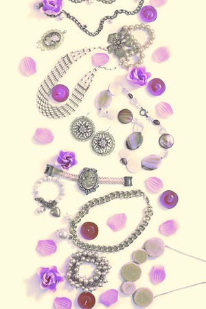 Surrealism Set of women's jewelry in vintage style necklace, cameo, pearl bracelet and chain earrings on yellow background. The view from the top lay flat.の写真素材