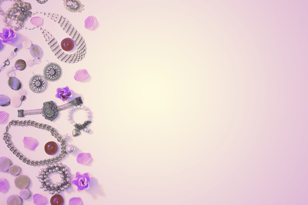 Surrealism Set of women's jewelry in vintage style necklace, cameo, pearl bracelet and chain earrings on pink background. The view from the top lay flat.の写真素材