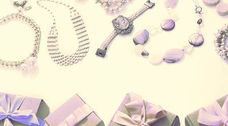 Banner Surrealism Set of women's jewelry in vintage style necklace, cameo, pearl bracelet and chain earrings on light background. The view from the top lay flat.の写真素材