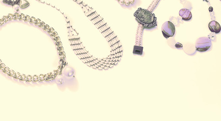 Banner Surrealism Set of women's jewelry in vintage style necklace, cameo, pearl bracelet and chain earrings on light background. The view from the top lay flat.の写真素材
