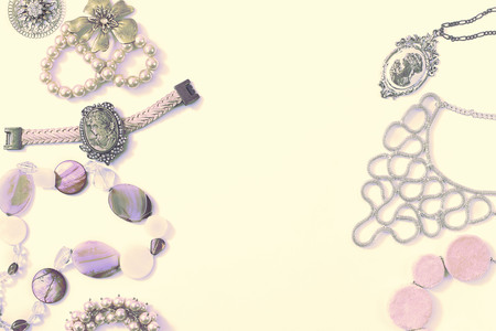 Surrealism Set of women's jewelry in vintage style necklace, cameo, pearl bracelet and chain earrings on light background. The view from the top lay flat.の写真素材