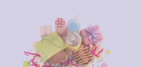 Festive composition of drinks, snacks, holiday hamburger, cookie, tinsel, confetti, gift box, cocktail and saturated colors. Children's holiday birthday partyの写真素材