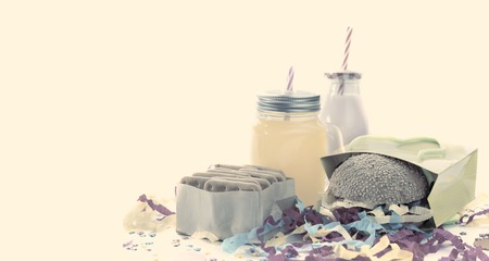 Festive composition of drinks, snacks, holiday hamburger, cookie, tinsel, confetti, gift box, cocktail and saturated colors. Children's holiday birthday partyの写真素材