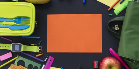 Banner Concept back to school of apple, backpack and stationery on black background. Top view flat layの写真素材