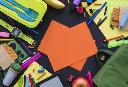 Concept back to school of apple, backpack and stationery on black background. Top view flat layの写真素材