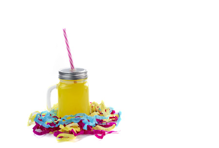 Decorative composition festive exotic cocktail on white background box with confetti gift and satin ribbon. Natural drink in a glass mugの写真素材