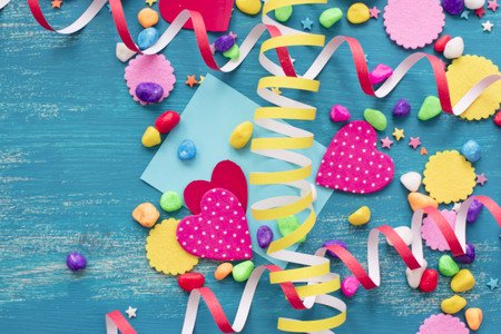 Festive confetti background heart candy color saturated. Wood old blue background with copy space flat layの写真素材