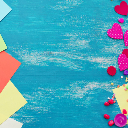Festive confetti background heart candy color saturated. Wood old blue background with copy space flat layの写真素材