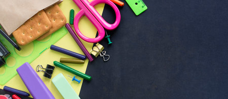 Banner Concept back to school watch chalk line cookies stationery on black background. Top view Flat...