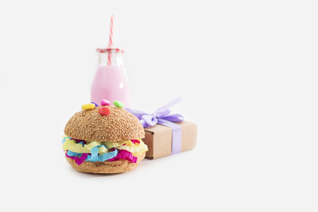 Festive composition drinks snacks holiday hamburger cookie tinsel confetti gift box cocktail cactus saturated colors. Children's holiday birthday partyの写真素材