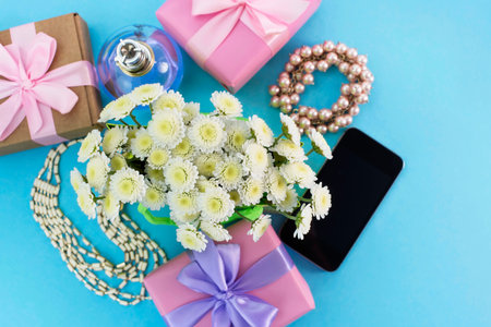 Decorative composition boxes with gifts flowers women's jewelry shopping holiday blue background....