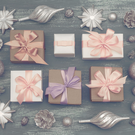 Festive composition flat lay Christmas toy balls cones snowflakes silver box wooden vintage background. Top view copy spaceの写真素材