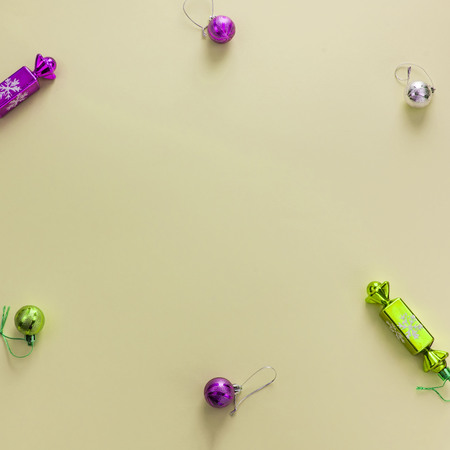 Decorative background yellow Christmas composition Flat lay Christmas tree toys candy balls. Top view, copy spaceの写真素材