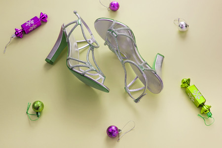 Decorative background yellow Christmas composition Flat lay box gift ribbon bow snowflake sandals silver Christmas tree toys. Top view copy spaceの写真素材