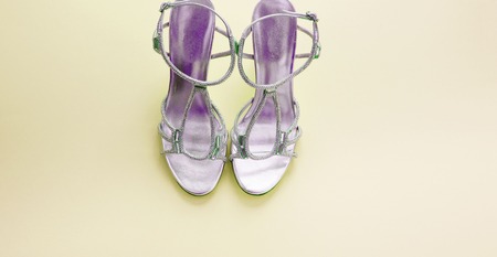 Banner Fashionable womens sandals silver color on a yellow background.の写真素材