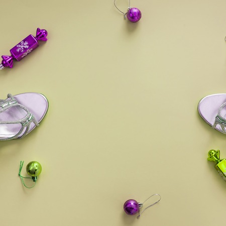 Decorative background yellow Christmas composition Flat lay box gift ribbon bow snowflake sandals silver Christmas tree toys.の写真素材