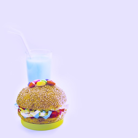 Festive composition drinks snacks holiday hamburger cookie tinsel confetti gift box cocktail saturated colors. Children's holiday birthday partyの写真素材