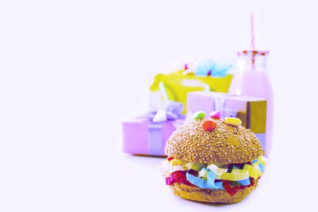 Surrealism Festive composition drinks snacks holiday hamburger cookie tinsel confetti gift box cocktail cactus saturated colors. Children's holiday birthday partyの写真素材