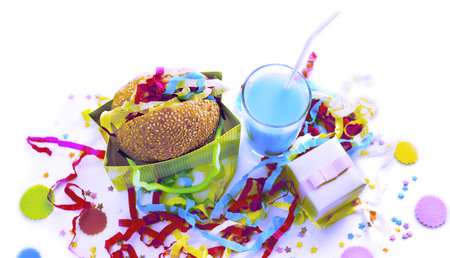 Surrealism Festive composition drinks snacks holiday hamburger cookie tinsel confetti gift box cocktail saturated colors. Children's holiday birthday partyの写真素材