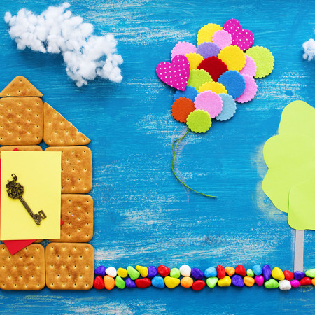 The concept of a cookie house on a wooden blue sky cloud background family path. Top view Flat layの写真素材