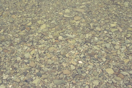 Natural abstract background of sea pebbles. Decorative textured backdrop.の写真素材