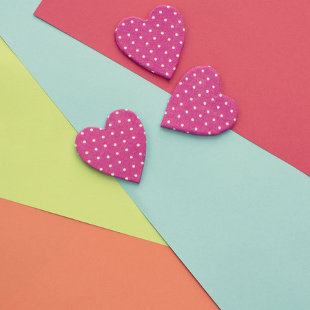 Colored sheets of paper on a wooden painted blue background decorative heart Valentine's day. Graphic design copy spaceの写真素材