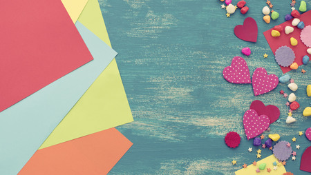 Festive confetti background heart candy color saturated. Wood old blue background with copy space flat layの写真素材