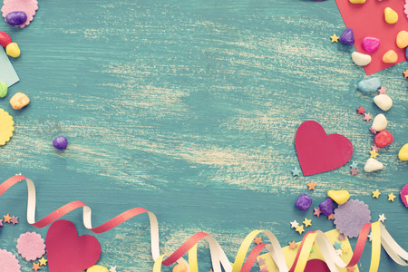 Festive confetti background heart candy color saturated. Wood old blue background with copy space flat layの写真素材