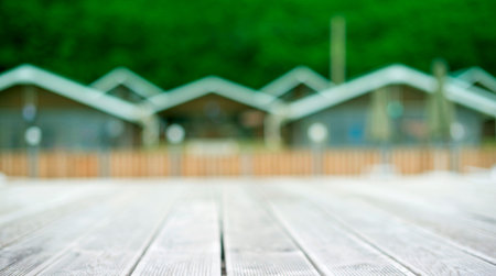 Banner Rustic landscape wooden houses hill forest sky. Defocus beautiful nature