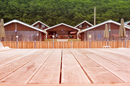 Rustic landscape wooden houses hill forest sky.の写真素材