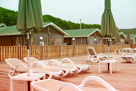 Country club recreation recreation relax pool wooden house forest trees sun lounger umbrella. Beautiful natural landscapeの写真素材