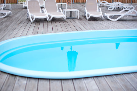 Wooden deck beach sea ocean resort sun lounger umbrella hotel pool sky sunrise. Relax by the sea on...