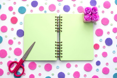 Colored confetti on white background notepad flat lay top view. Festive background copy space toolsの写真素材