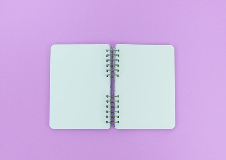 Open Notepad on purple background. Top view flat layの写真素材