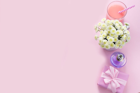 Decorative composition flat lay set of items flowers perfume cocktail gift. Top view copy spaceの写真素材