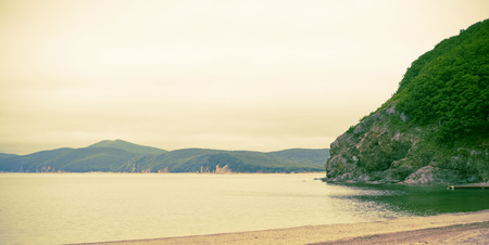 Banner seascape morning dawn horizon sea coast Bay hill sea pebble autumn. Natural background sea beach copy spaceの写真素材