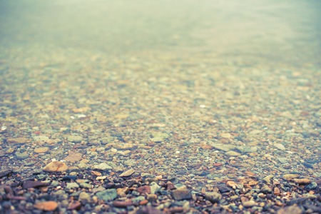Defocus Natural abstract background of sea pebbles. Decorative textured backdrop.の写真素材