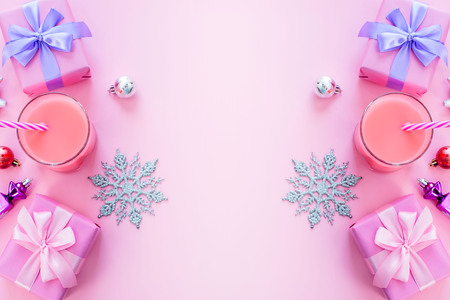 Festive background for text composition flat lay Christmas items gift box ribbon bow pink glass cocktail Christmas toys. Top view copy spaceの写真素材