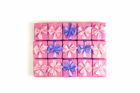 Rows of boxes with gifts decoration ribbon satin bow pink. A top view of Flat layの写真素材