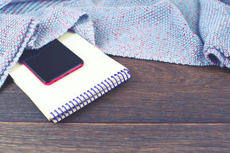 Empty space on your desktop mobile phone gadget. Old natural wooden shabby background knitted blanket plaid purple colorの写真素材