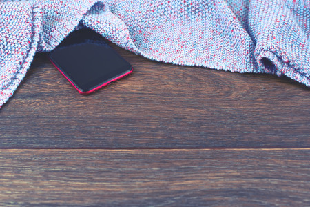 Empty space on your desktop mobile phone gadget. Old natural wooden shabby background knitted blanket plaid purple colorの写真素材