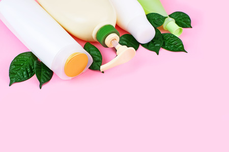 Cosmetics for hair and body care white bottles on a pink background natural organic product. Copy space, selective focusの写真素材