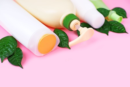 Cosmetics for hair and body care white bottles on a pink background natural organic product. Copy space, selective focusの写真素材