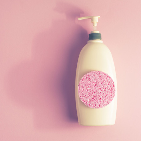 Large package shampoo, shower gel, body cream, Spa, sponge. Top view copy space pink backgroundの写真素材