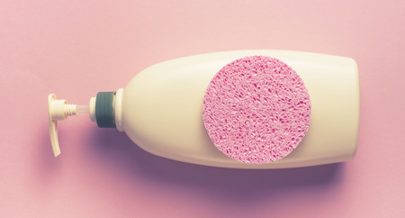 Large package shampoo, shower gel, body cream, Spa, sponge. Top view copy space pink backgroundの写真素材