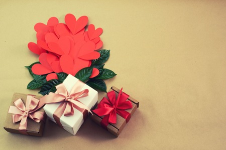 Flying red hearts concept of Valentines day. Top view flat lay. Decorated boxes with giftsの写真素材