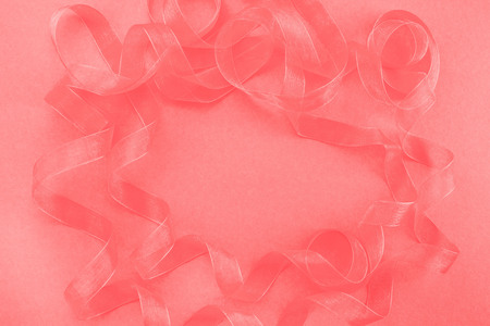Abstract textured coral background. Ribbon curls top viewの写真素材