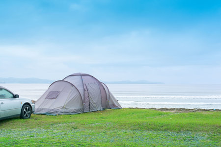 Seascape summer travel machine tent rubber boat Coastline horizon sky with cloudsの写真素材