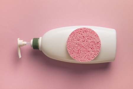 Body care hair cream bottle sponge. Coral backgroundの写真素材